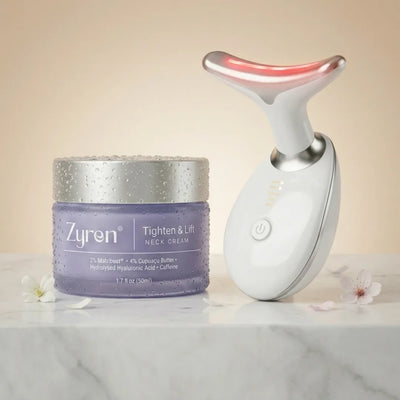 Zyren Neck Lift System: Tighten & Lift Neck Cream 50ml jar next to the white LED neck sculptor on marble